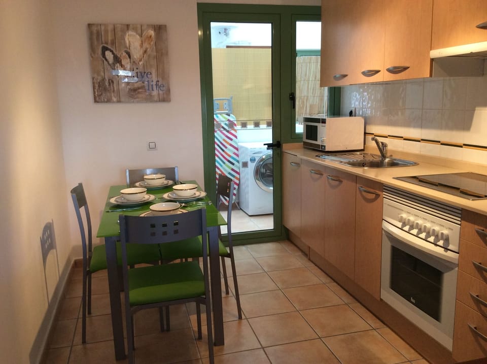 Fully fitted kitchen with door into utility with washer and boiler