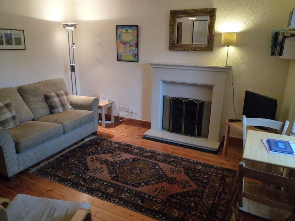 Living room with double sofa bed with dining area
