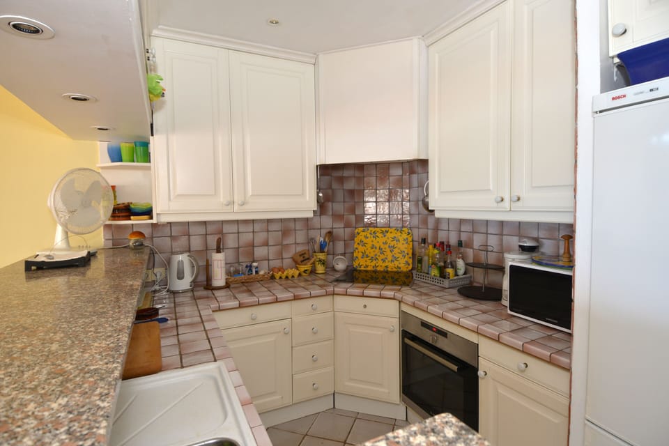 Well equipped kitchen with views across living area to the sea.