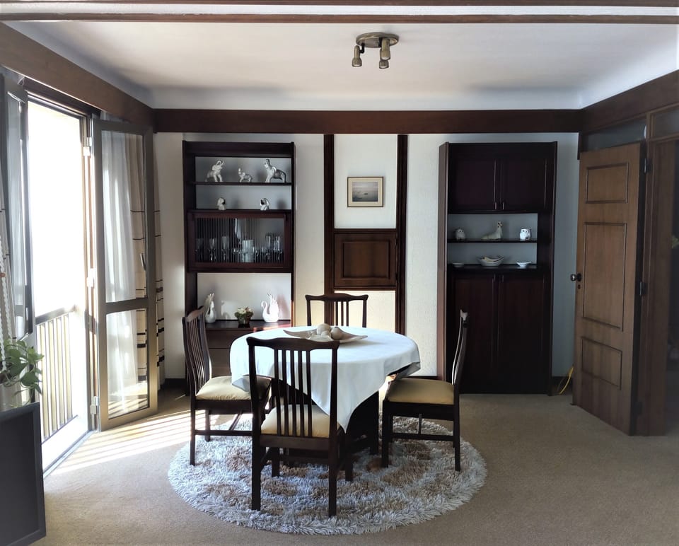 Dining room end, with open french doors with sea views. 


