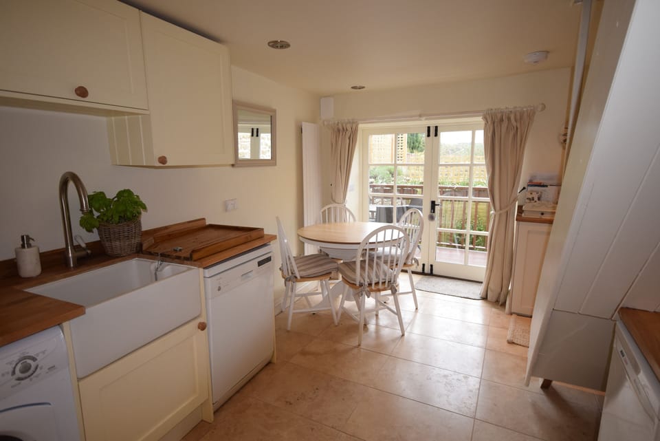 Pretty kitchen dinning room with decking to garden