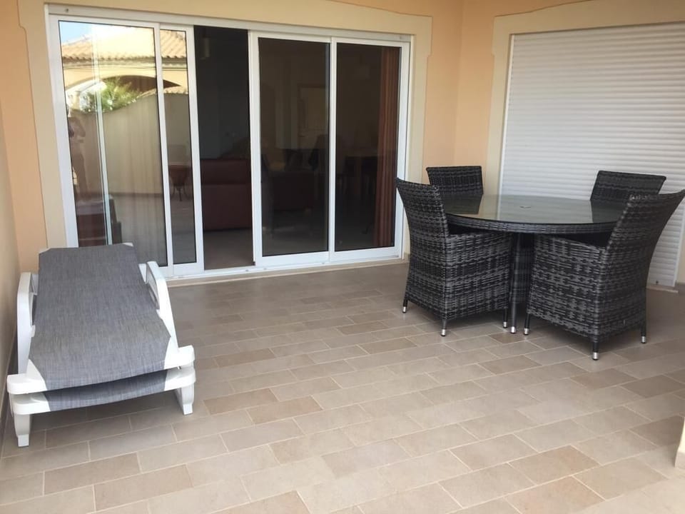 Large balcony with seating and sun loungers