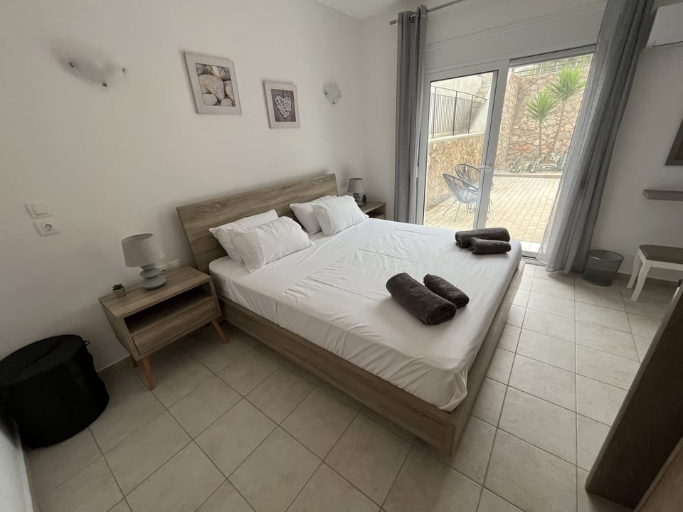 Bedroom with patio doors leading out to private courtyard. 