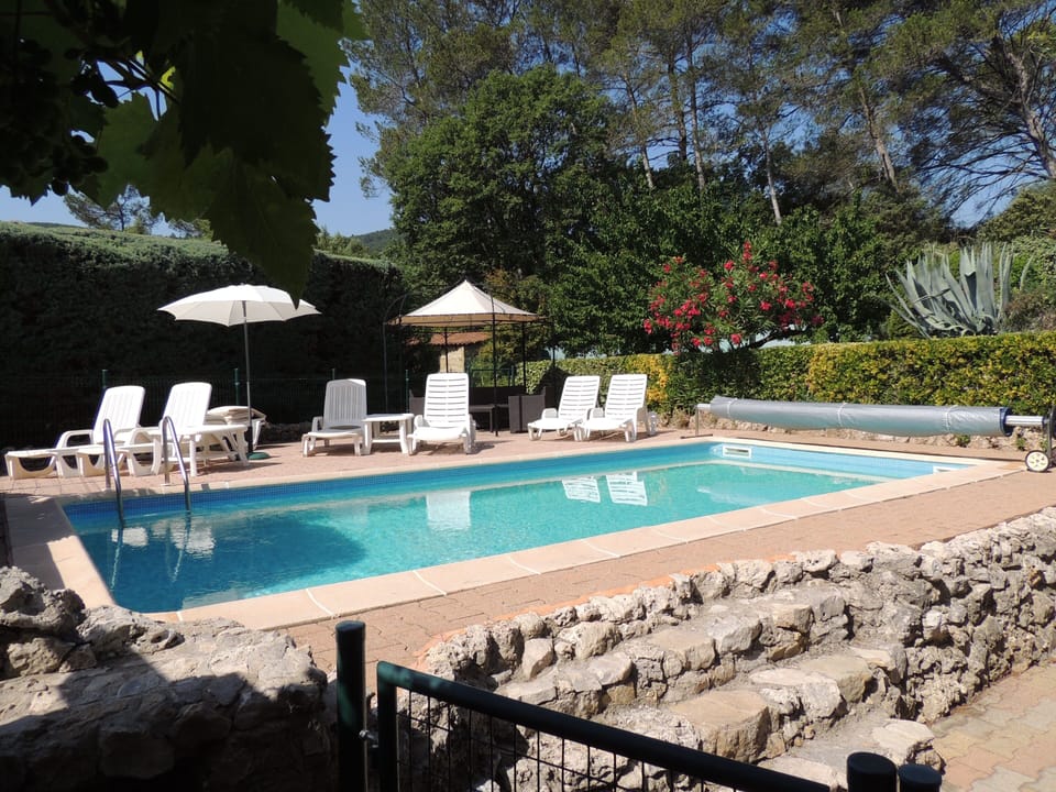 Pool and sunbathing area seen from main terrace security gate