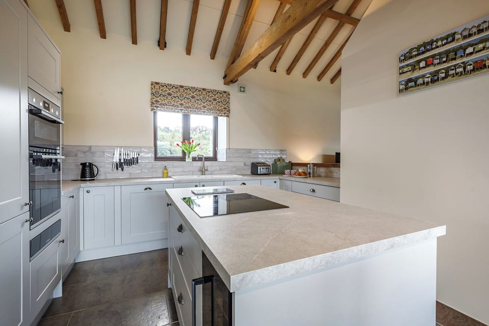 Kitchen with integrated fridge freezer and bottle fridge.  
