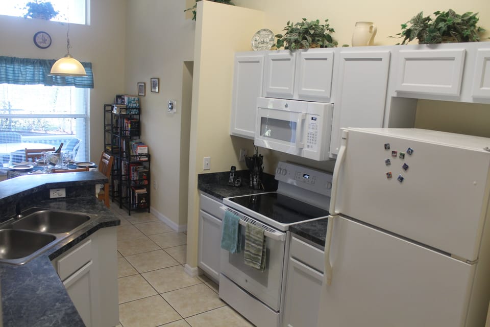 Kitchen view across breakfast nook to pool deck/
