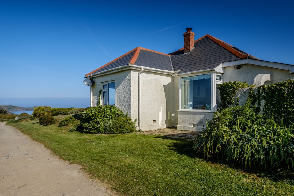 Side of house on track to sea
