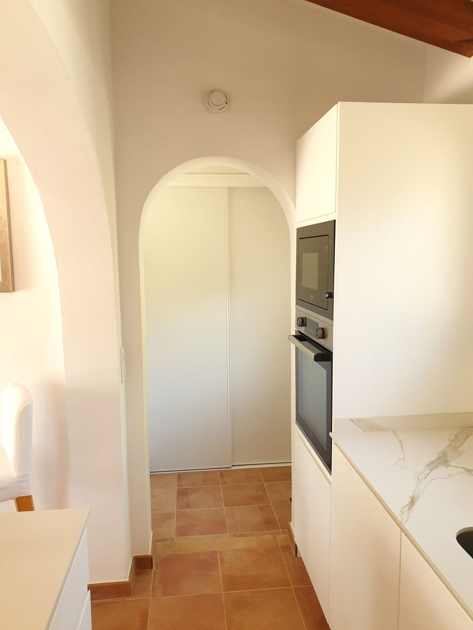 View to Utility room, sliding doors concealing Fridge Freezer and Washer/Dryer