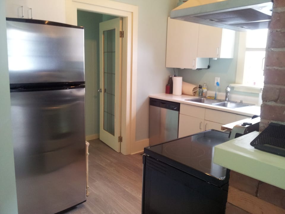 Bright efficient kitchen with new stainless steel appliances