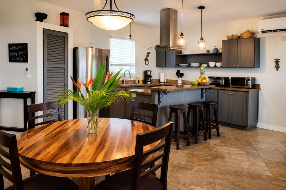 Enjoy morning coffee and evening meals in the open dining area, seamlessly connected to the fully equipped kitchen and breakfast bar.
