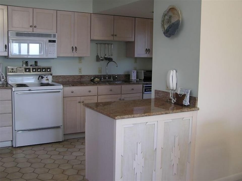 Updated kitchen with custom cabinets and granite counters