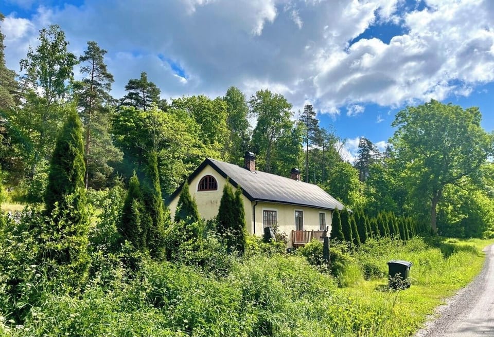 The house nestled in all the greenery of the garden.