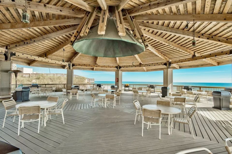 Massive beach & poolside pavilion with grills and dining space. 