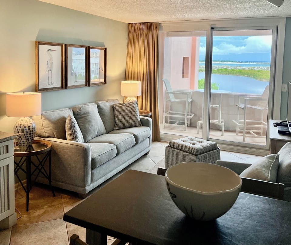 Living space & balcony w/bay & sunset views
