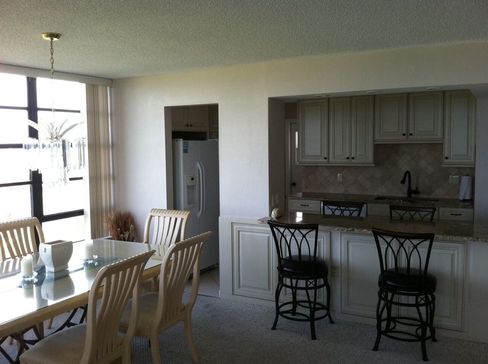 kitchen with double door refrigerator, ice maker, dish washer, stove, oven, etc.
