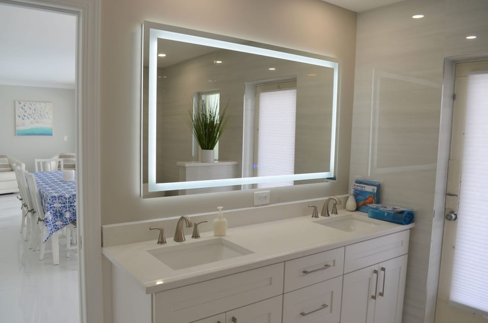 Master bath vanity. His/hers sinks and lighted mirror.