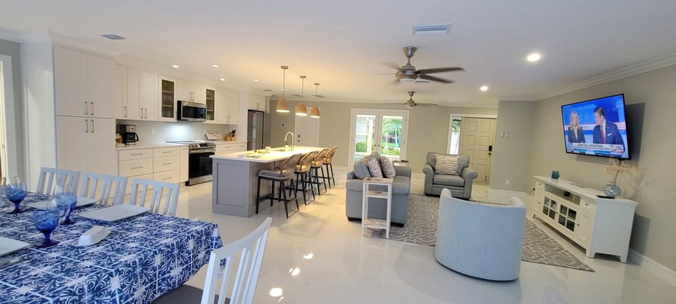 Open concept main area, from pool side. Xfinity cable TV.