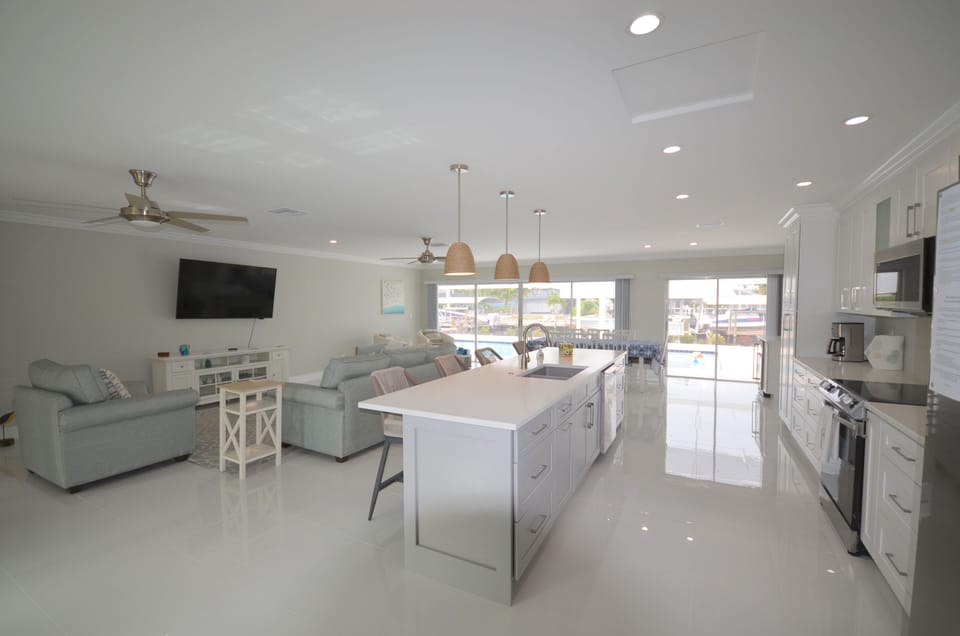 Kitchen, living area, and dining area overlooking the pool and lanai