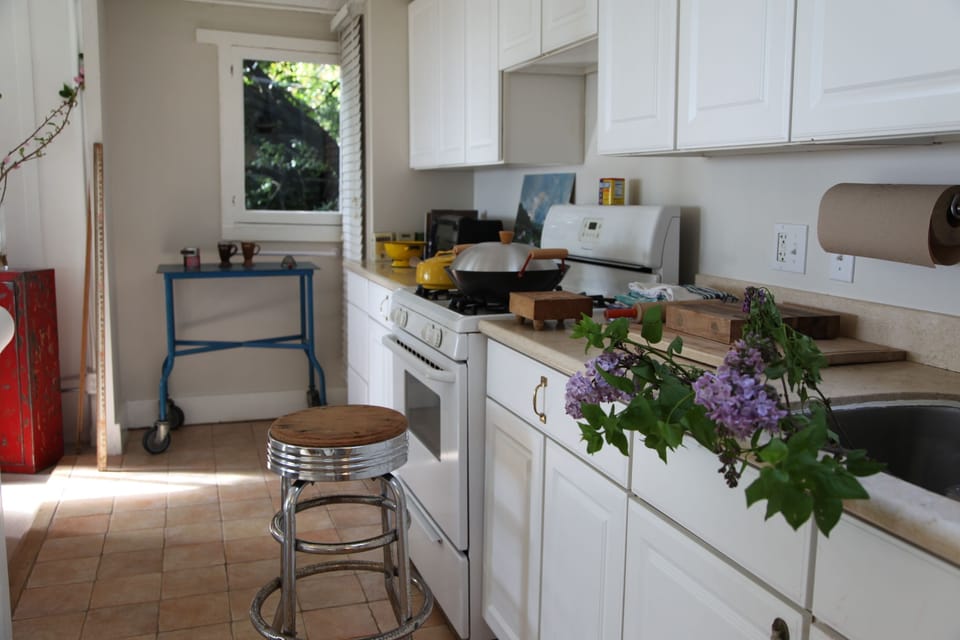 full size kitchen with wonderful dishware, large full fridge, oven and farm sink