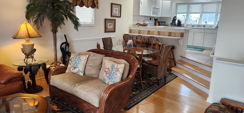 living room flowing into dining area and full kitchen