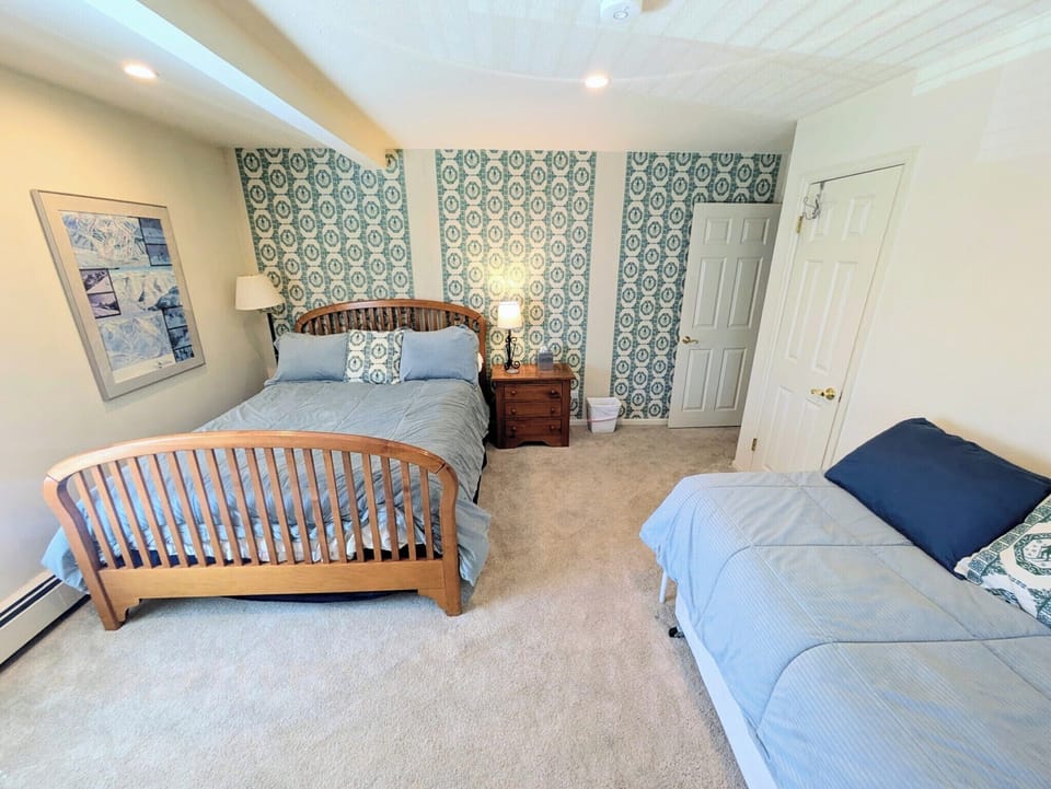 This spacious bedroom sleeps four.  Designer Pintura Studios wallpaper and more.