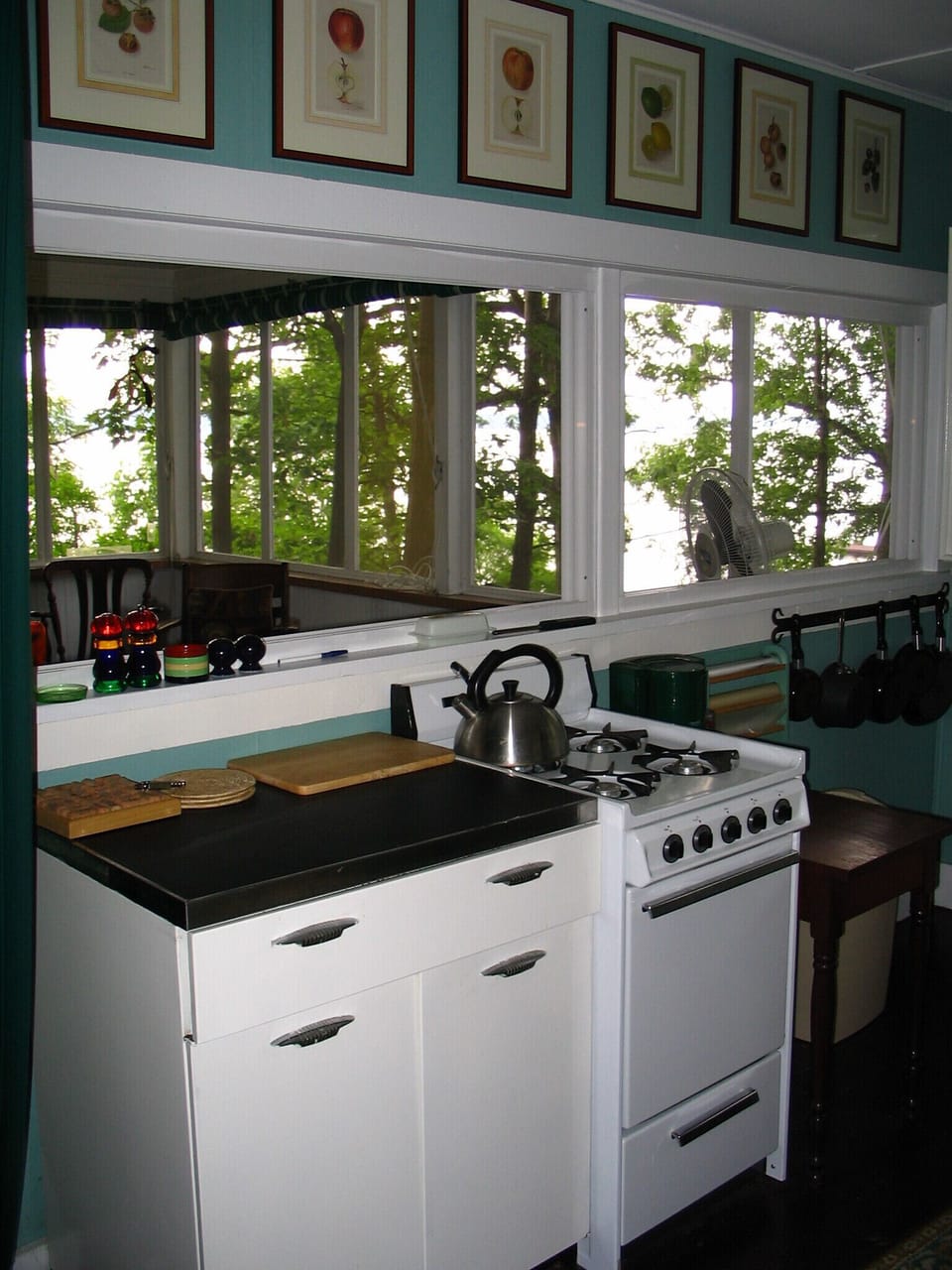 Other side of the kitchen, looking through the windows to the porch.
