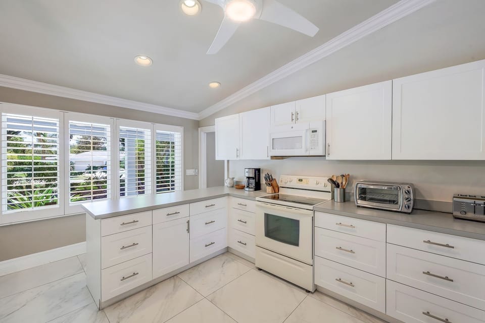 Bright sun-drenched kitchen with vaulted ceilings