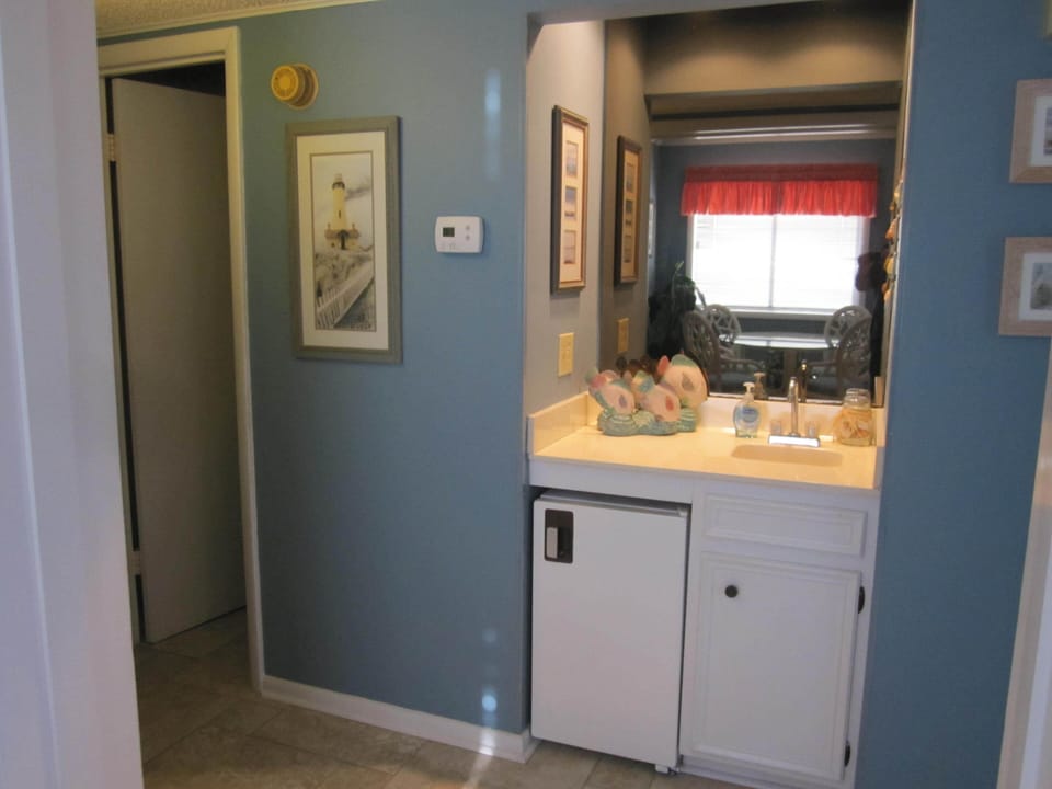 Wet bar with extra beverage refrigerator.