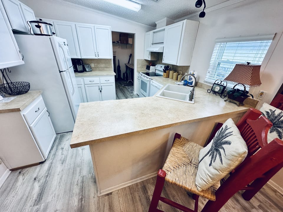 Fully stocked kitchen with bar seating and full laundry room 