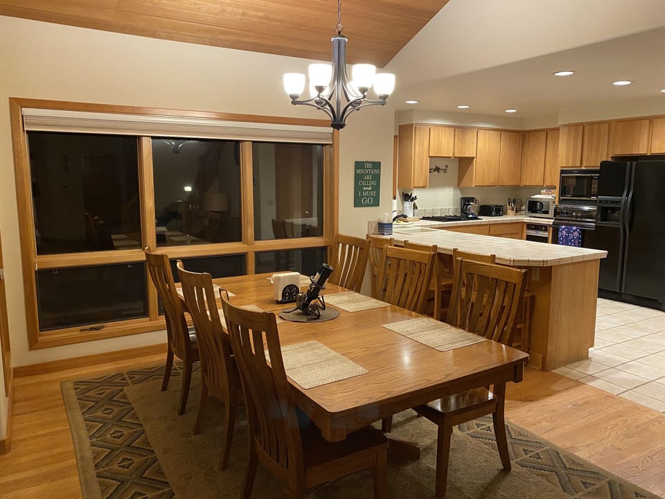 View from dining room into kitchen. Additional island and kitchen table seating.