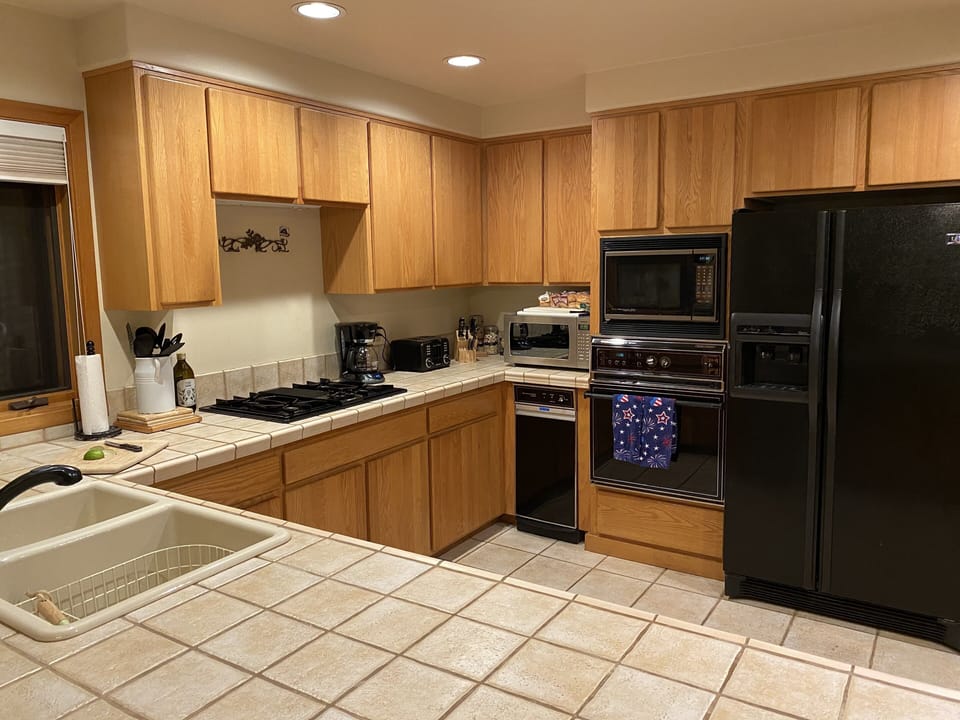 Kitchen fully stocked with large walk in pantry providing ample storage.
