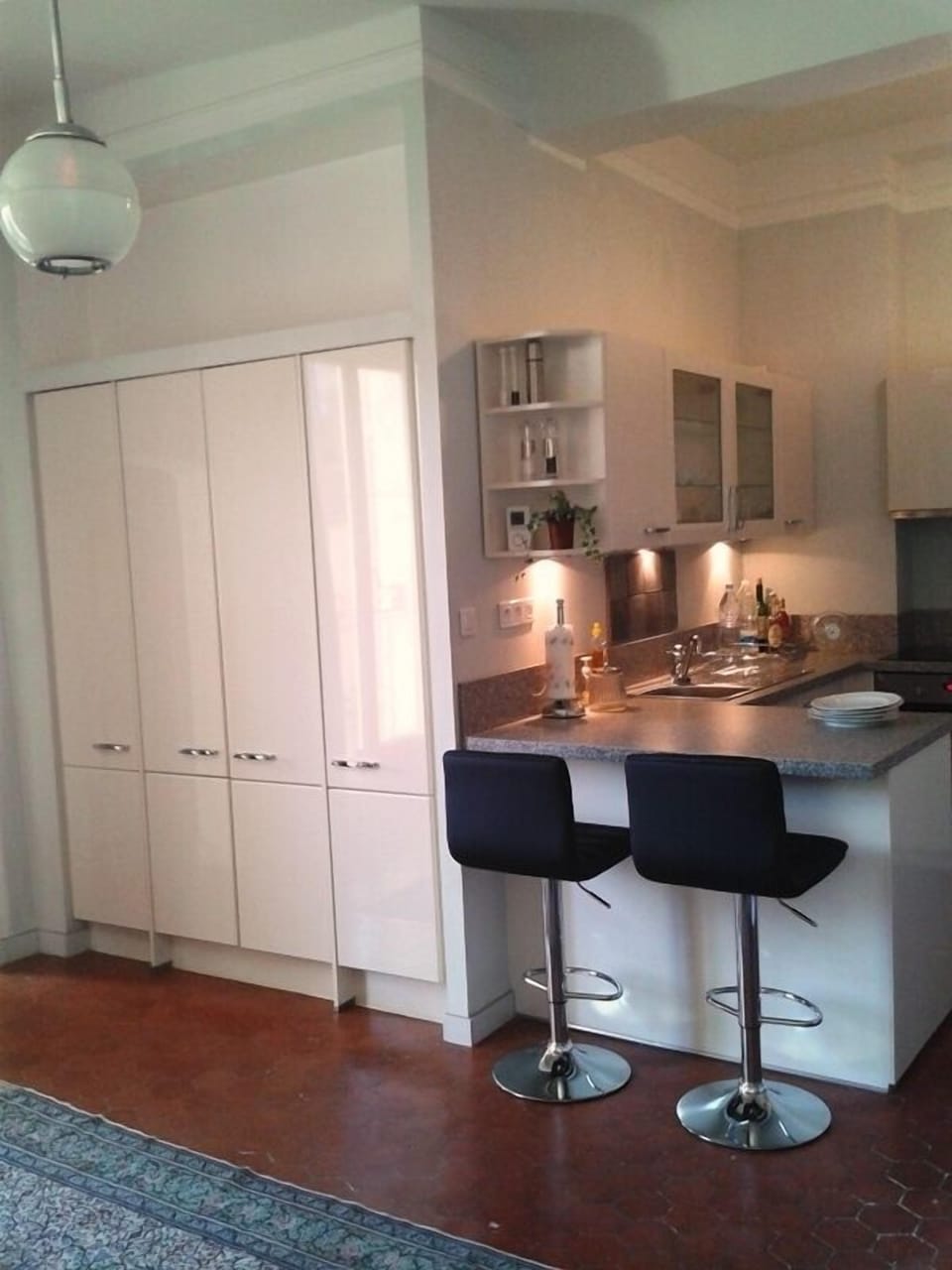 View of the kitchen from dining room, past closets, on the left, is the bedroom.