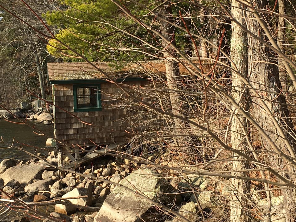 Boat house with three kayaks. 