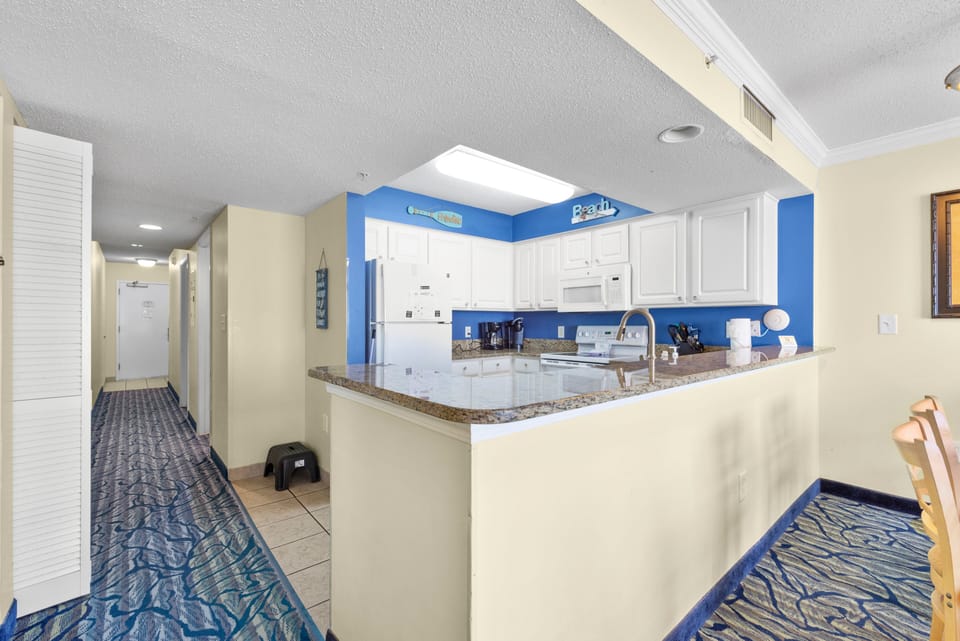 Large kitchen with granite counter tops, flat top stove and full size dishwasher