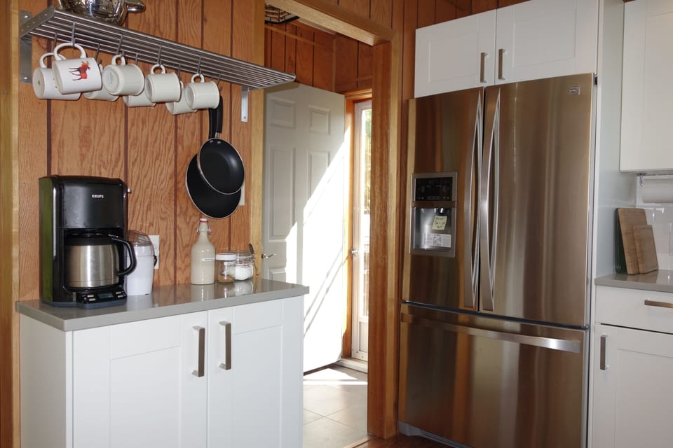 Kitchen coffee station & fridge.
