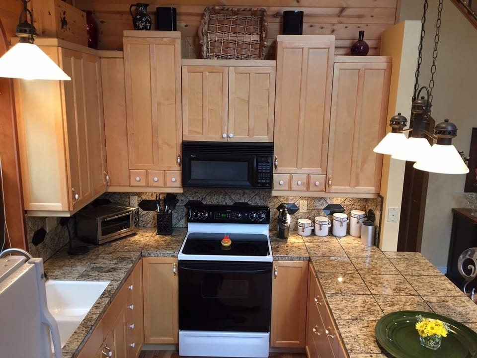 European Birch Cabinets with Microwave above Electric Stove