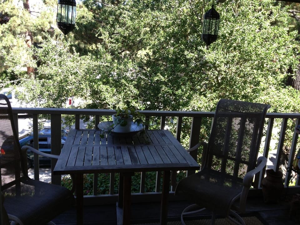 Balcony overlooks tree shaded cul de sac