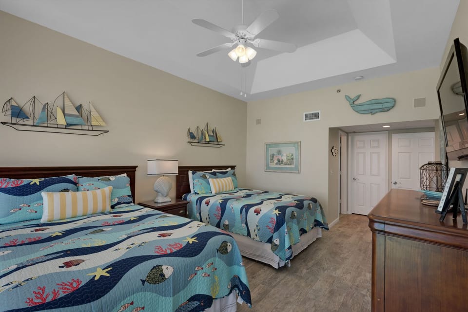 Large guest room with vaulted ceilings and charming coastal décor.
