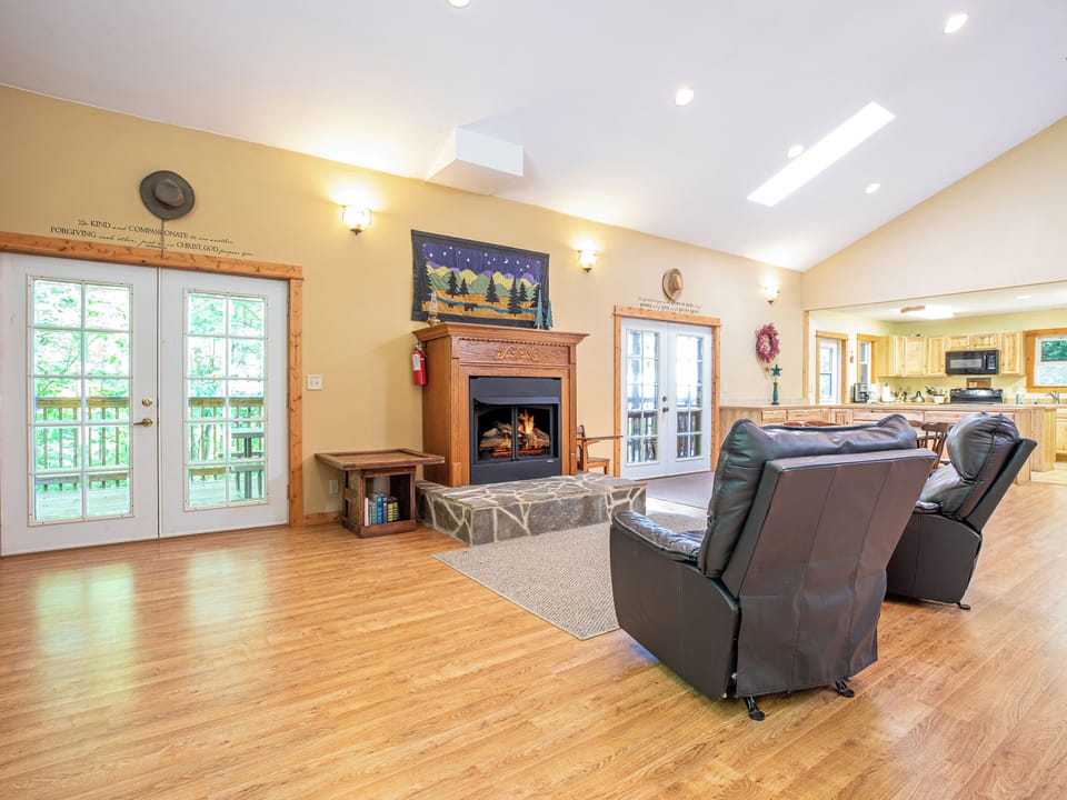 Gas log fireplace. The kitchen can be seen on the right side of the photo. 