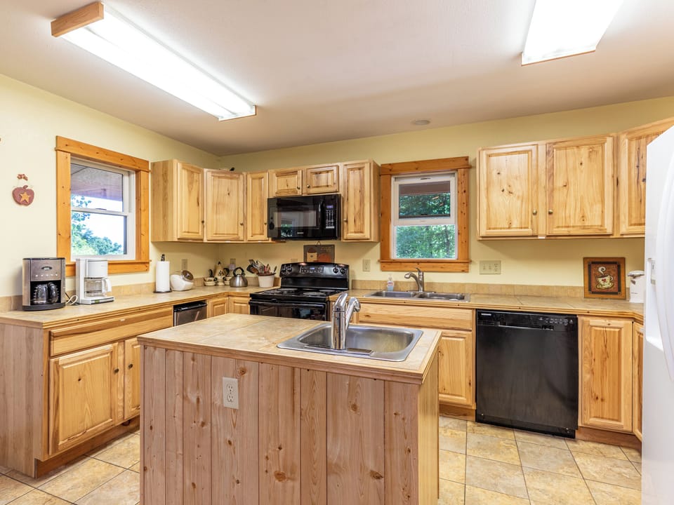 Full kitchen stocked with dishware and cookware.