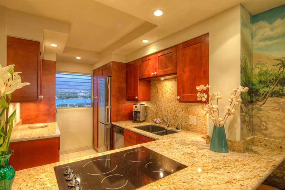 Fully equipped kitchen with cherry cabinets and granite countertops.