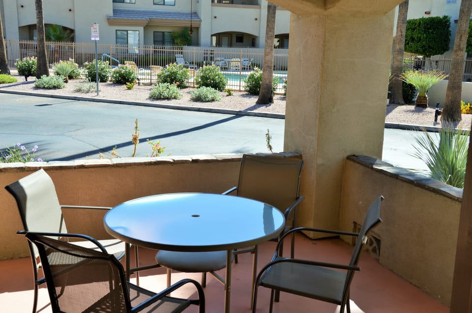Covered private Patio with unobstructed view of  Pool area in center of complex