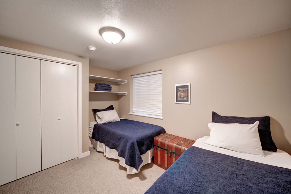 3rd bedroom on lower level includes 2 twin beds with adjoining 3/4 bath. 
