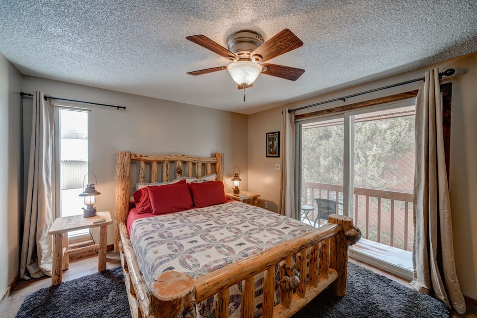 This quaint 2nd Floor bedroom includes 1 queen bed and a small balcony. 