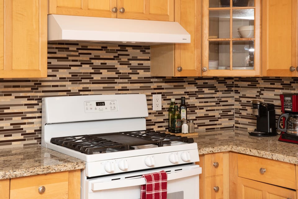 Granite kitchen counter w/ gas stove and center griddle.