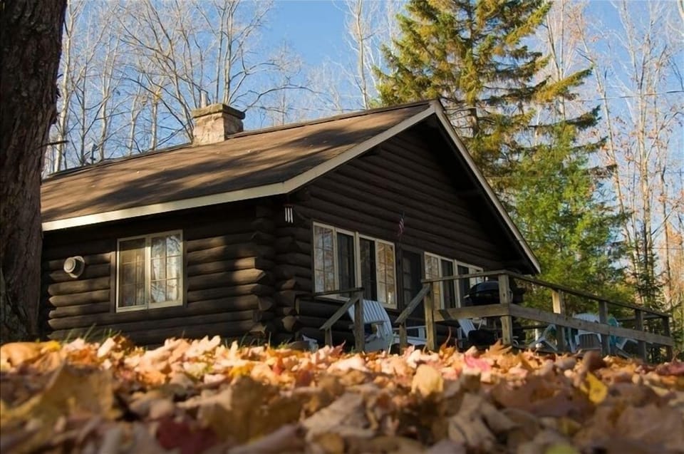 Deck has a charcoal grill and table with four chairs