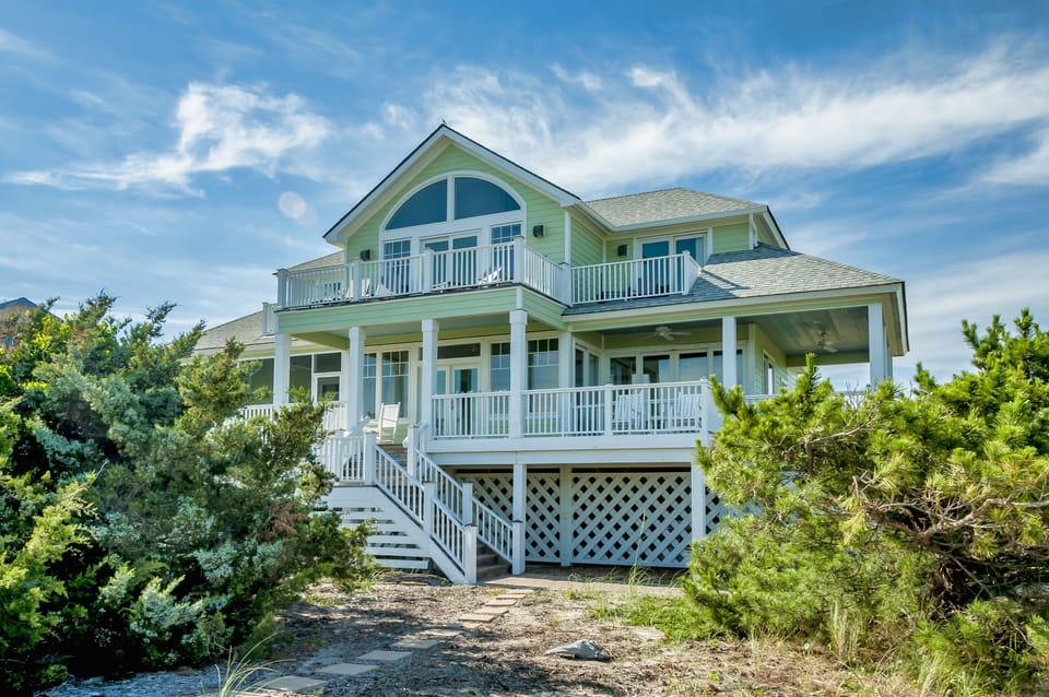 Beautifully renovated home surrounded by porches/decks from almost every room.