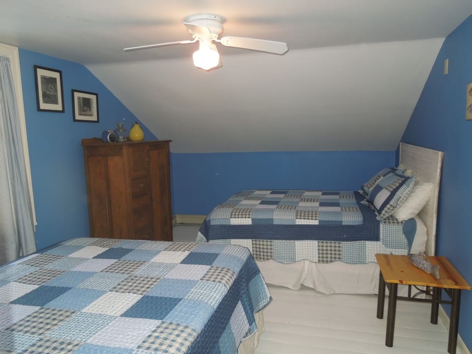 2 queen beds in "blue room" with armoire