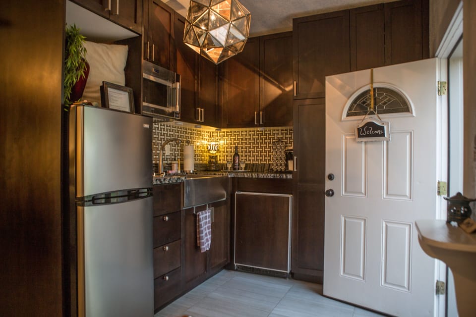 Quaint kitchen. Large sized fridge and separate under counter freezer.