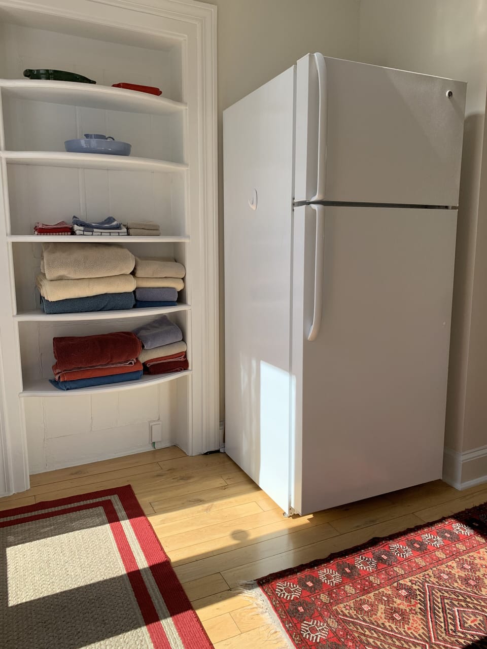 Full sized refrigerator and fresh towels
